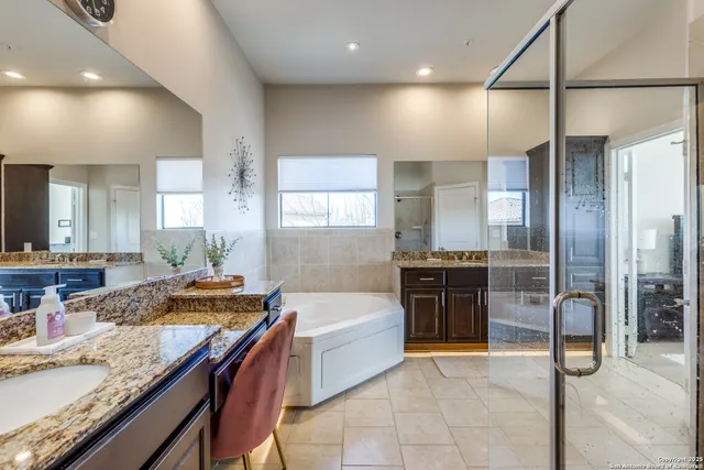 a large kitchen with stainless steel appliances granite countertop a sink and a refrigerator