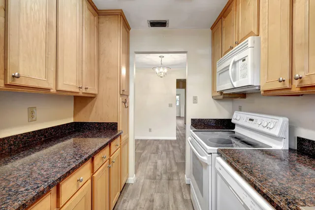 a kitchen with stainless steel appliances granite countertop a stove a sink and a granite counter tops