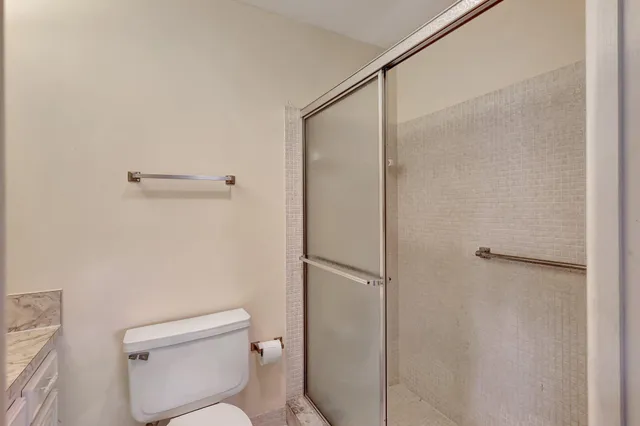 a bathroom with a toilet and a shower
