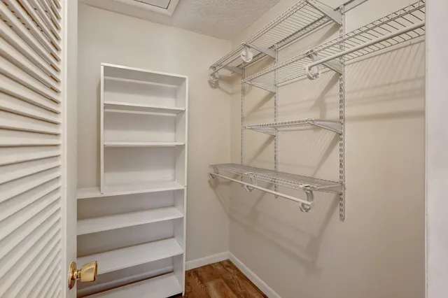 a view of walk in closet with empty racks