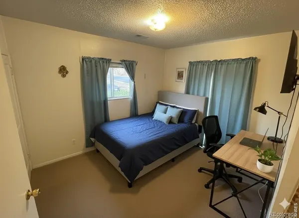 a bedroom with a bed and a table in it