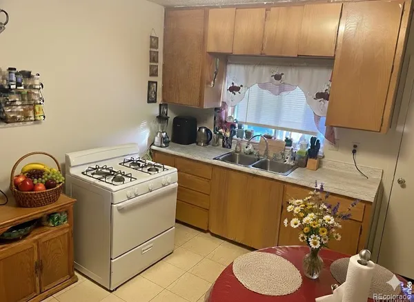 a kitchen with a stove a sink and a cabinets