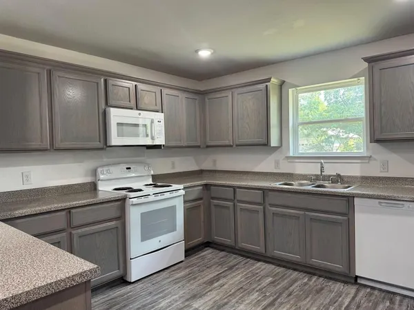 a kitchen with a sink stove and cabinets