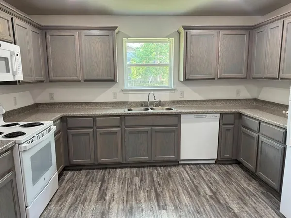 a kitchen with a sink stove and cabinets