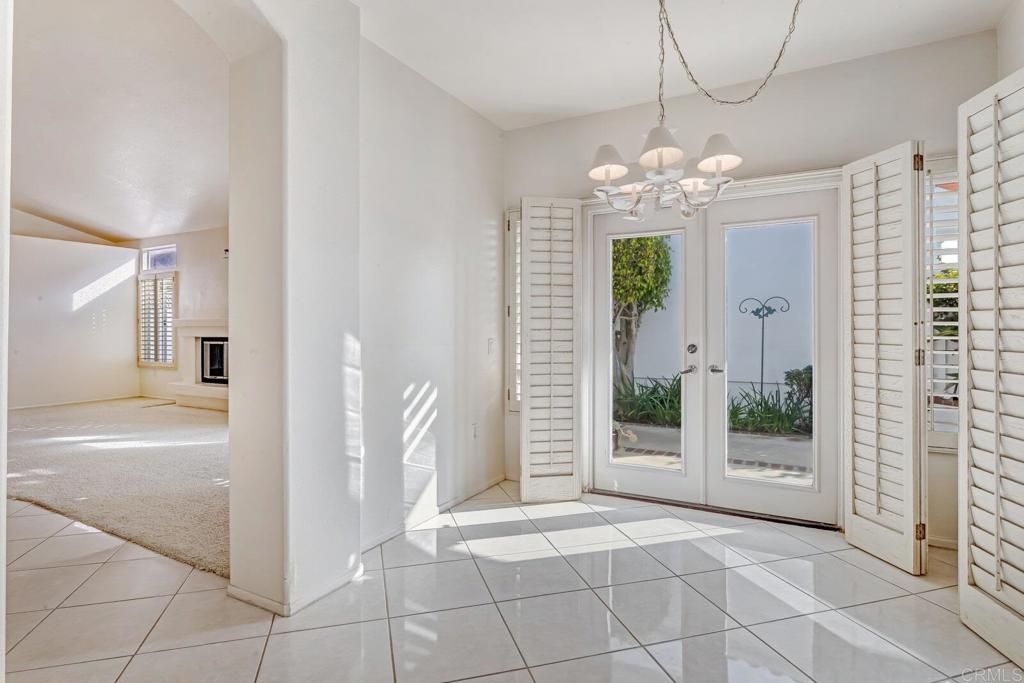 4144 Andros Way Oceanside, CA 92056 - Photo 13 of 29 a view of a hallway with wooden floor and a chandelier