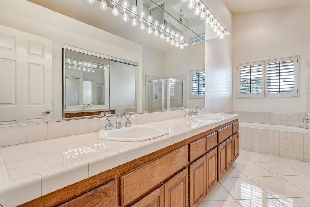 4144 Andros Way Oceanside, CA 92056 - Photo 16 of 29 a bathroom with a double vanity sink and a mirror