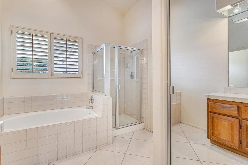 4144 Andros Way Oceanside, CA 92056 - Photo 17 of 29 a spacious bathroom with a bathtub and next to a window
