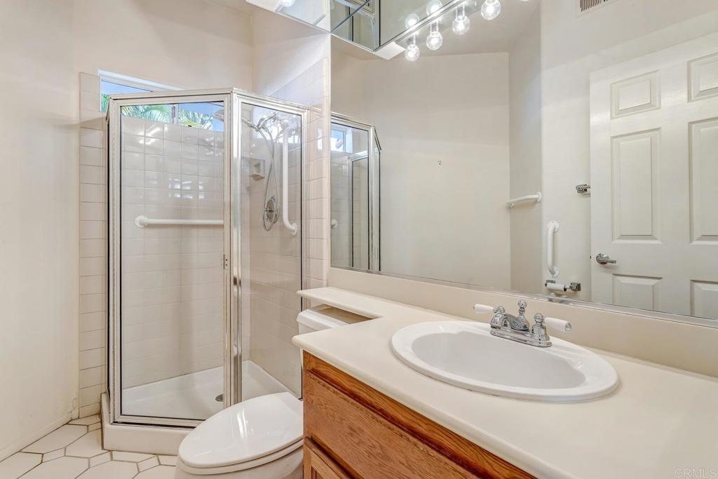 4144 Andros Way Oceanside, CA 92056 - Photo 21 of 29 a bathroom with a sink a toilet and shower
