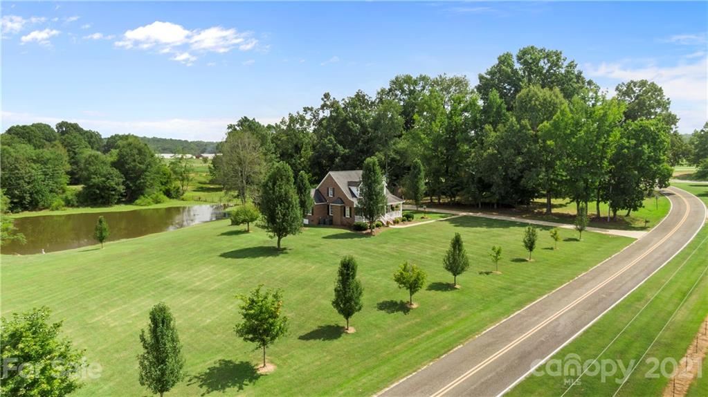 178 Buck Fraley Road Cherryville, NC 28021 - Photo 16 of 47 a view of a swimming pool with a garden and trees