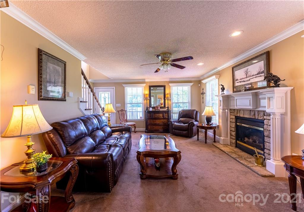 178 Buck Fraley Road Cherryville, NC 28021 - Photo 23 of 47 a living room with furniture a fireplace and a table