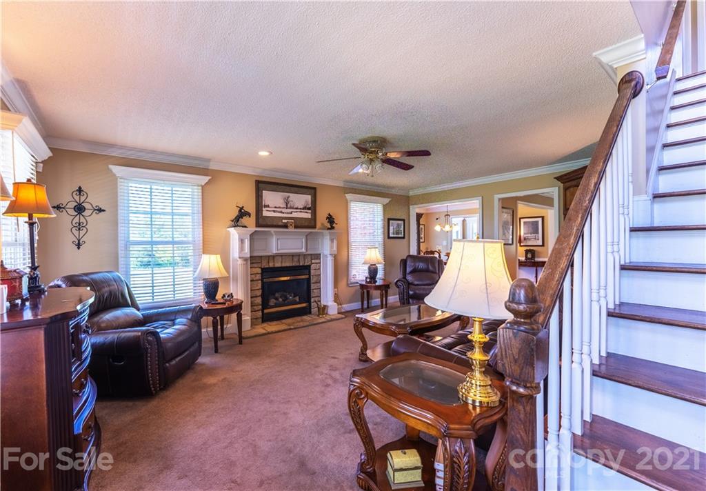 178 Buck Fraley Road Cherryville, NC 28021 - Photo 24 of 47 a living room with furniture a fireplace and a flat screen tv