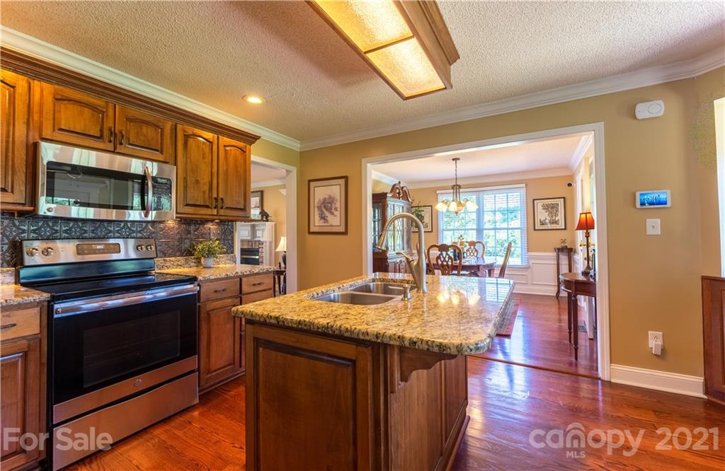 178 Buck Fraley Road Cherryville, NC 28021 - Photo 28 of 47 a kitchen with stainless steel appliances granite countertop a stove refrigerator and microwave