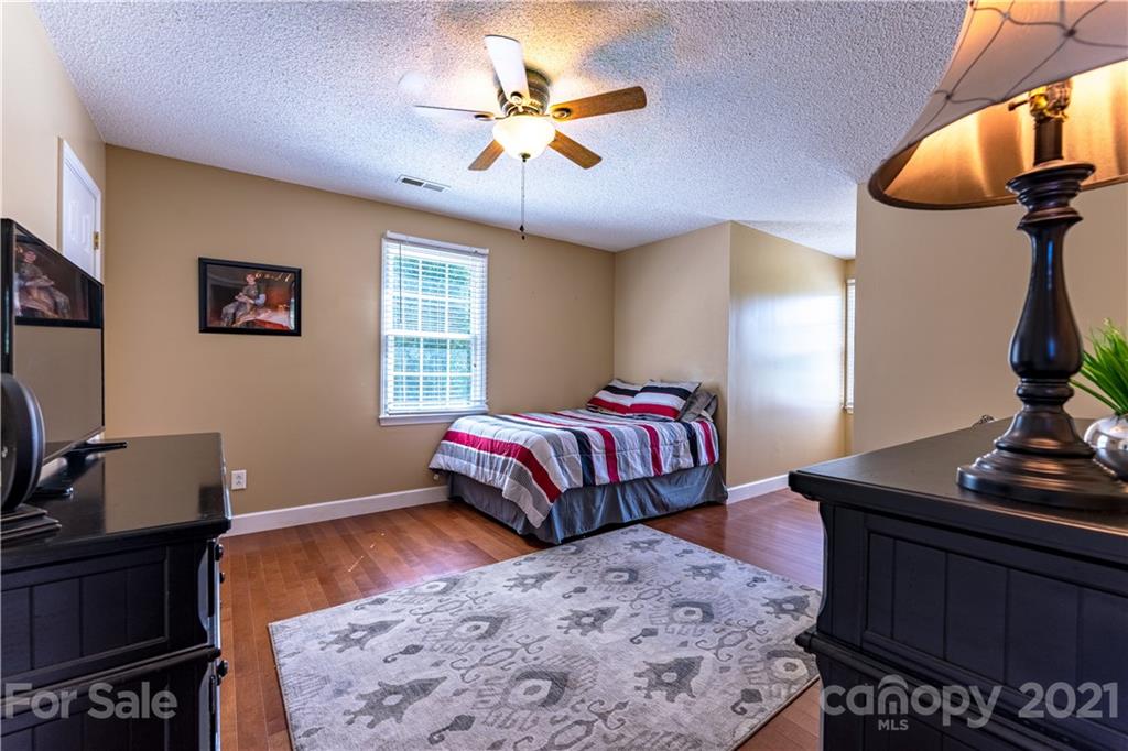 178 Buck Fraley Road Cherryville, NC 28021 - Photo 43 of 47 a bedroom with a bed and dresser with mirror