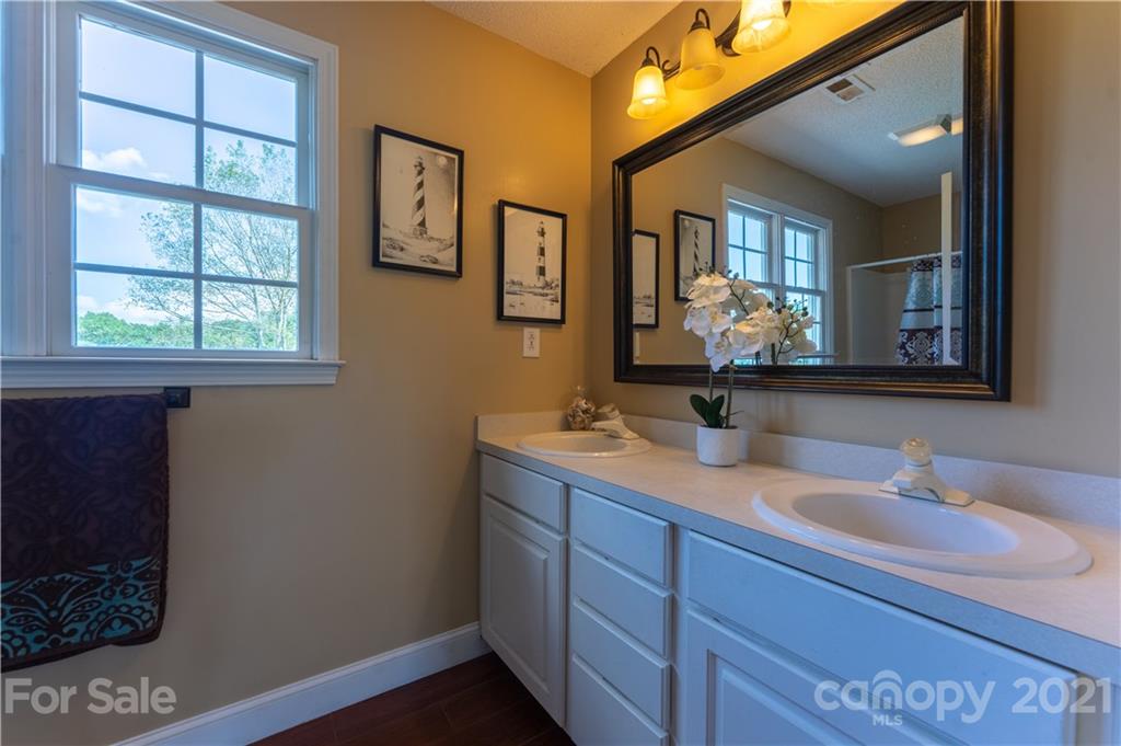 178 Buck Fraley Road Cherryville, NC 28021 - Photo 44 of 47 a bathroom with 2 sink and a mirror
