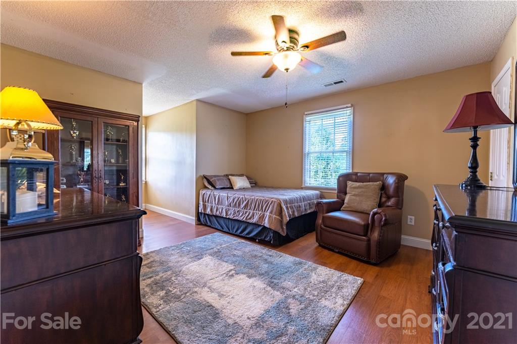 178 Buck Fraley Road Cherryville, NC 28021 - Photo 45 of 47 a bedroom with a bed and wooden floor