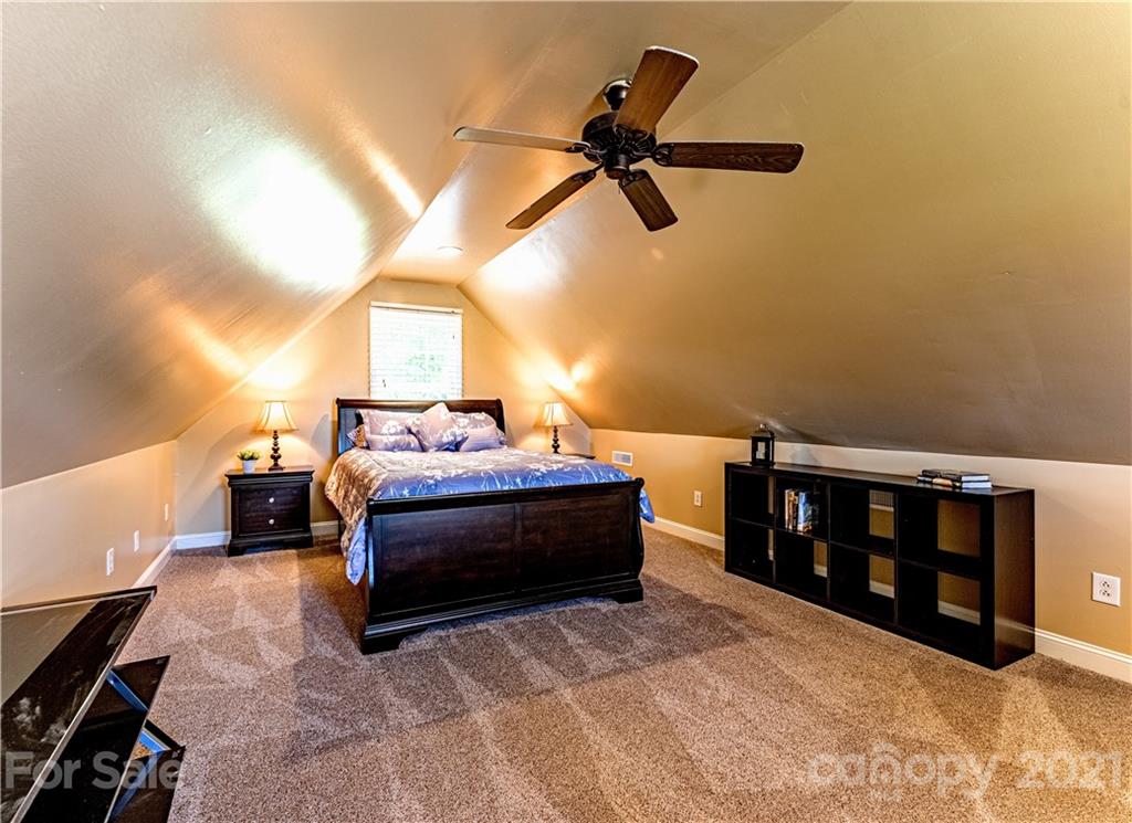 178 Buck Fraley Road Cherryville, NC 28021 - Photo 46 of 47 a spacious bedroom with a bed and a chandelier