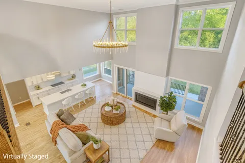 a view of a dining room with furniture a rug and wooden floor