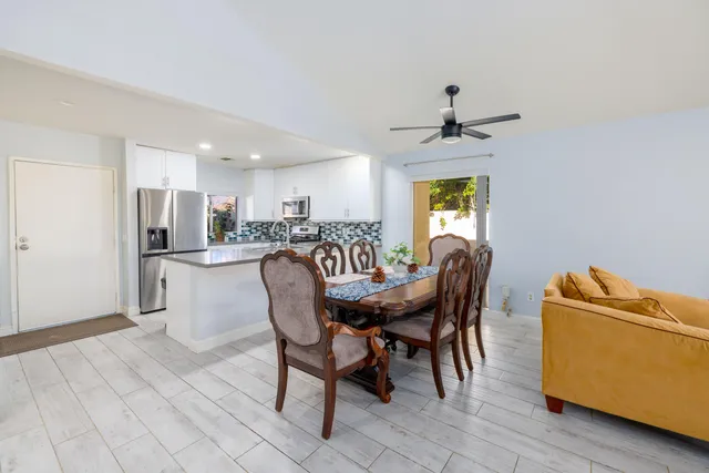 a dining room with furniture window and wooden floor