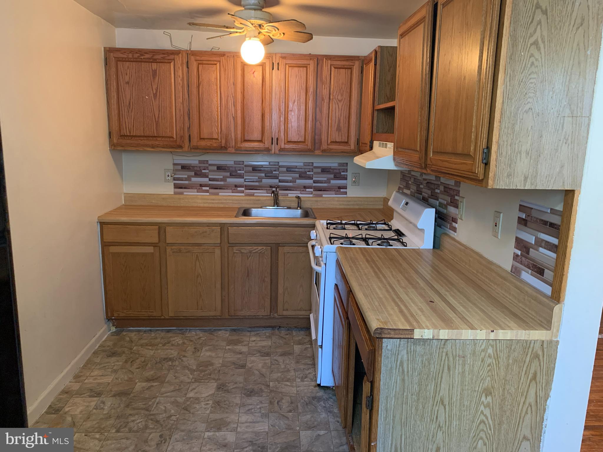 1305 Harshaw Road Brookhaven, PA 19015 - Photo 4 of 25 a kitchen with a stove a sink and a refrigerator