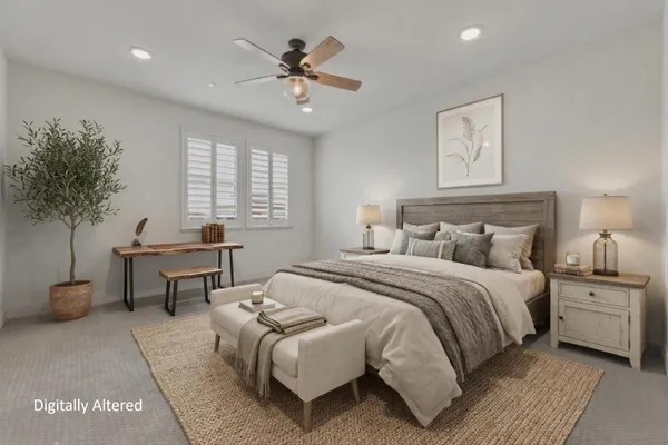 a bedroom with a bed and a potted plant