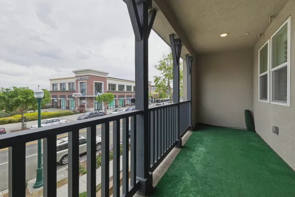 an empty room with fan and entrance
