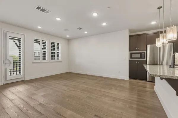 a view of kitchen with stainless steel appliances a refrigerator and a stove top oven