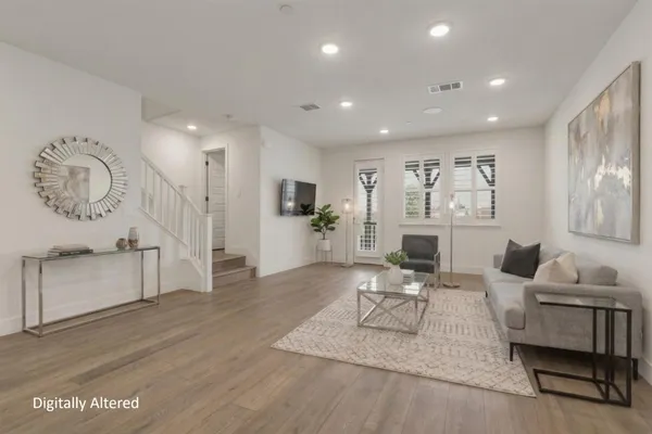 a living room with furniture a wooden floor and a fireplace