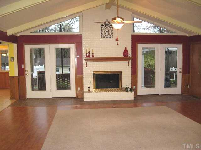 3817 Cheek Road Durham, NC 27704 - Photo 4 of 18 Great living room with cathedral ceiling, two ceiling fans, & brick fireplace Living Room
