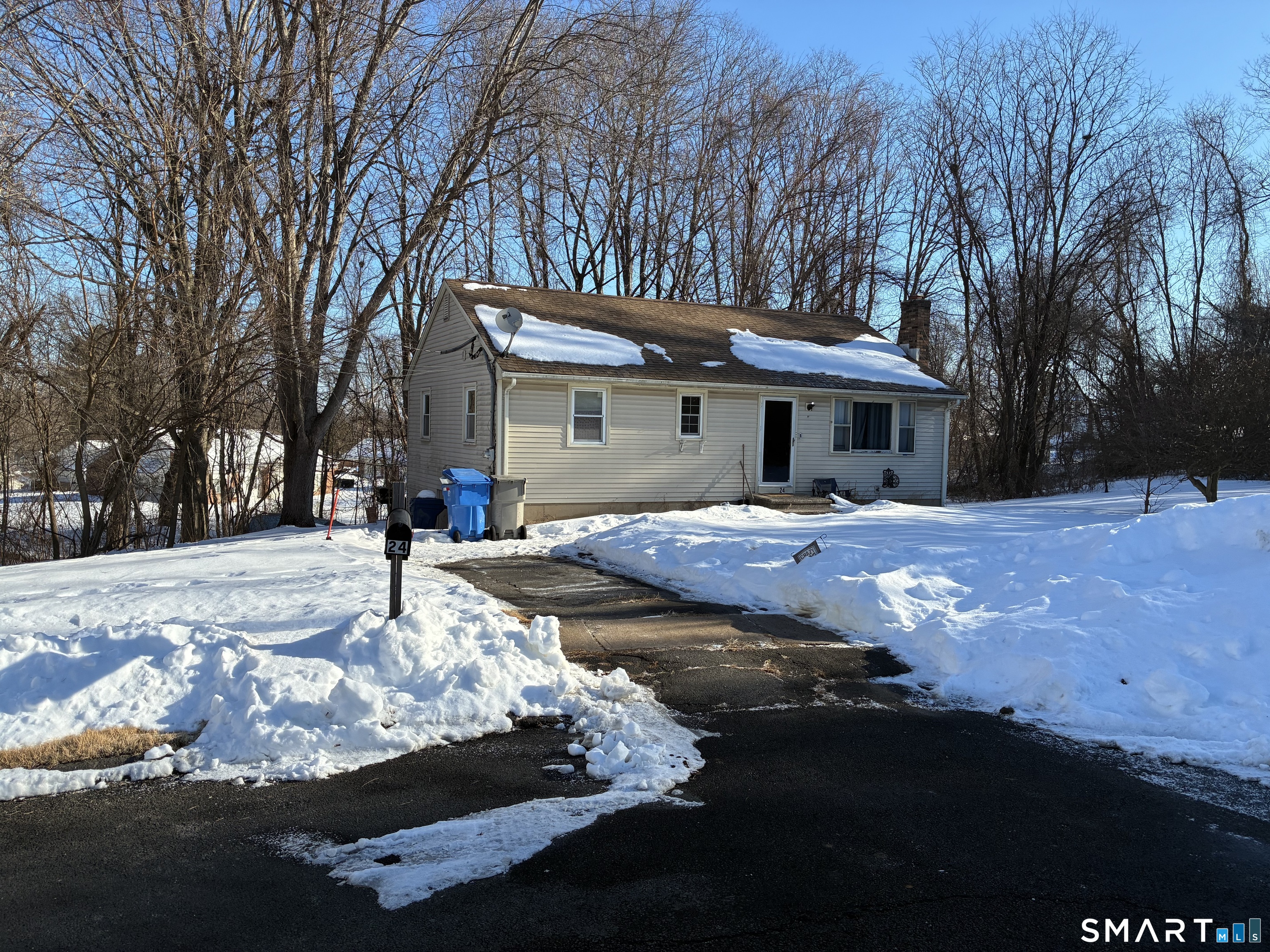24 MacArthur Court Bristol, CT 06010 - Photo 1 of 1 a front view of a house with a yard covered with snow