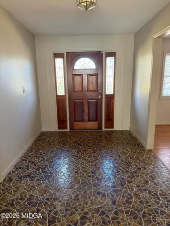 a view of a bathroom with mirror and tiles