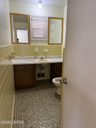 a bathroom with a sink a toilet and mirror