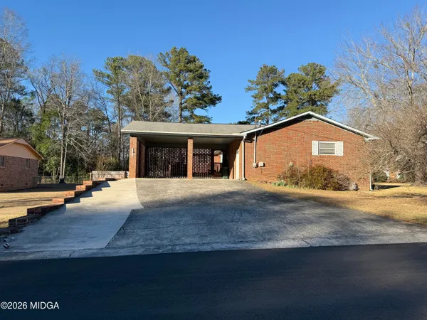 a view of a house with a garden and pathway