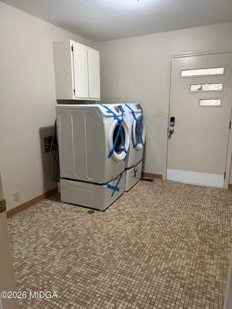 a utility room with washer and dryer