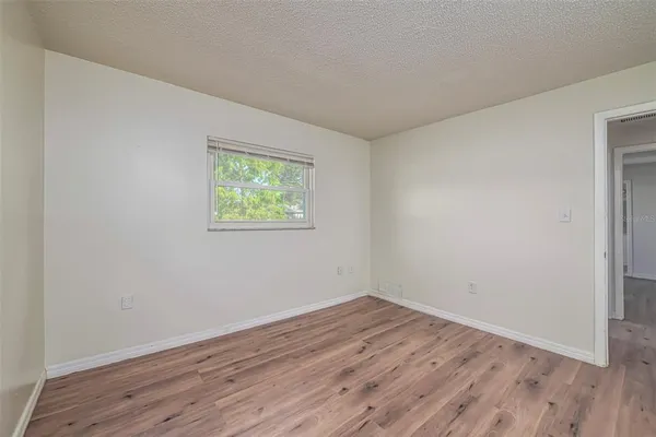 a view of room with wooden floor and window