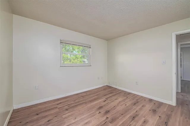 a view of room with wooden floor and window