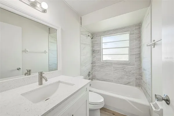 a bathroom with a sink toilet and bathtub