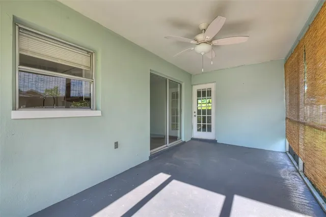 a view of a livingroom with a ceiling fan and window
