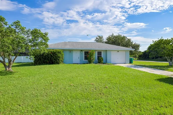 a view of a house with a backyard