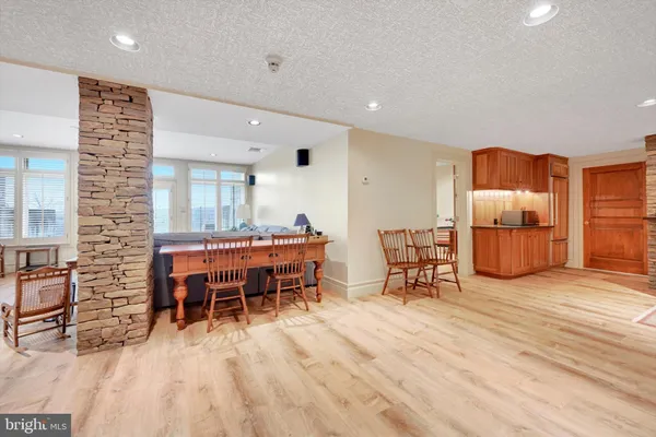 a dining room with furniture and wooden floor