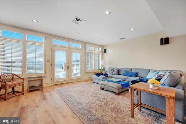a living room with furniture and large windows