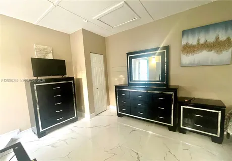 a kitchen with a refrigerator and a stove top oven