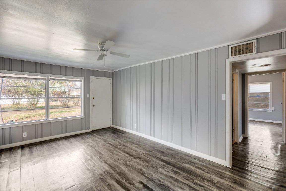 705 Campbell Street Lockhart, TX 78644 - Photo 15 of 30 an empty room with wooden floor and windows