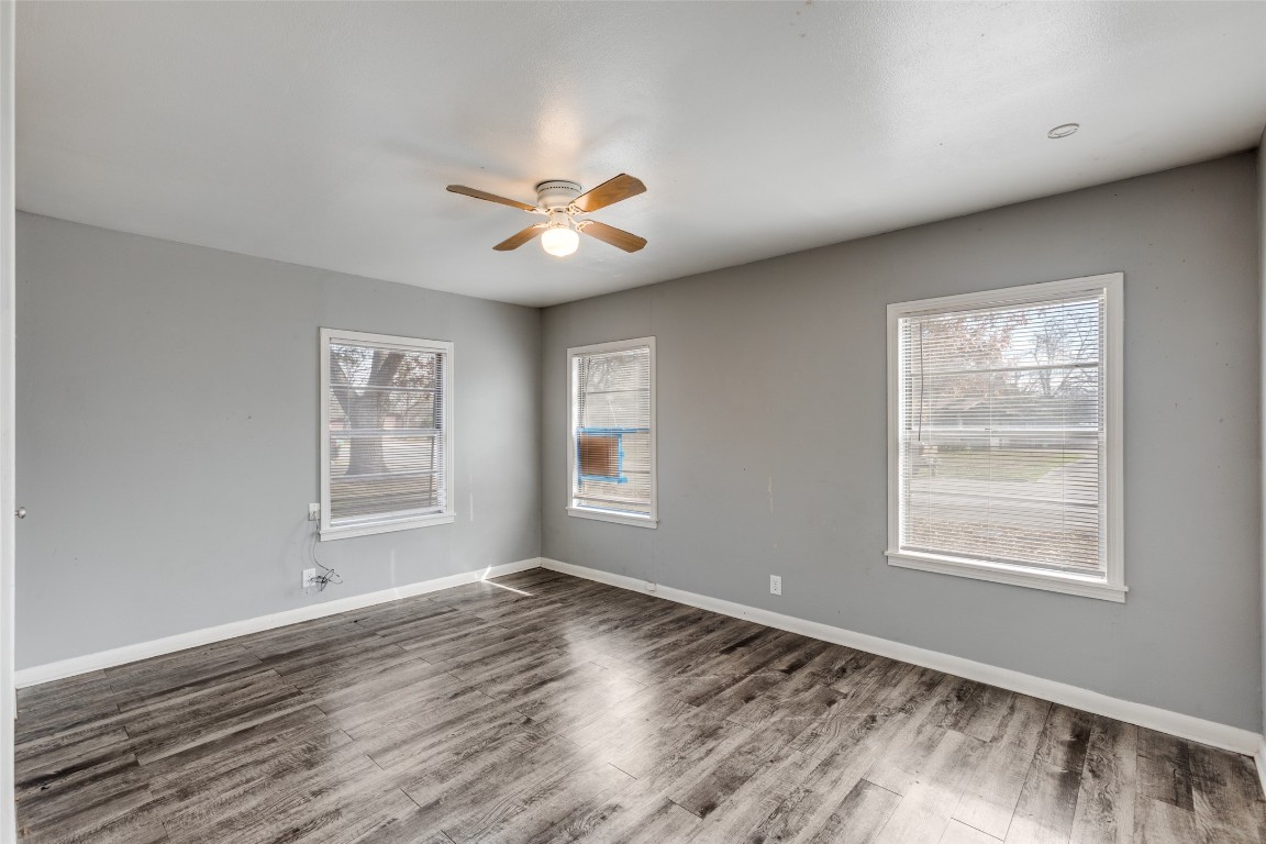 705 Campbell Street Lockhart, TX 78644 - Photo 18 of 30 a view of an empty room with a window and wooden floor