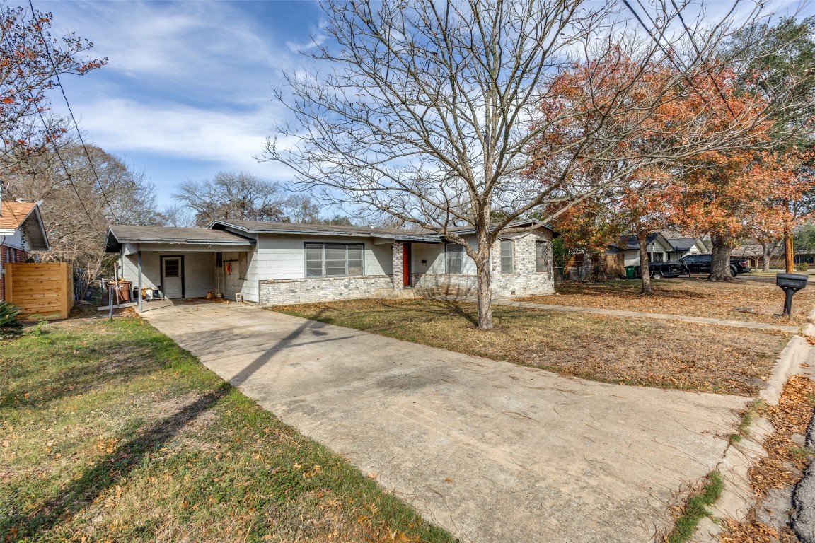 705 Campbell Street Lockhart, TX 78644 - Photo 2 of 30 a view of a yard in front of a house