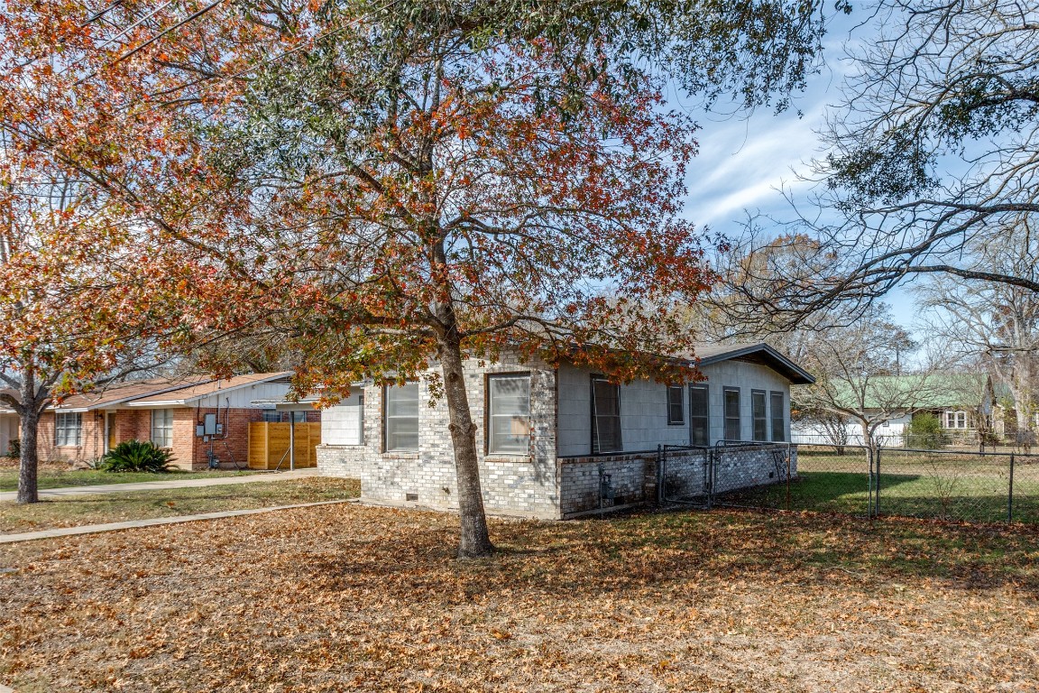705 Campbell Street Lockhart, TX 78644 - Photo 4 of 30 a front view of a house with a yard