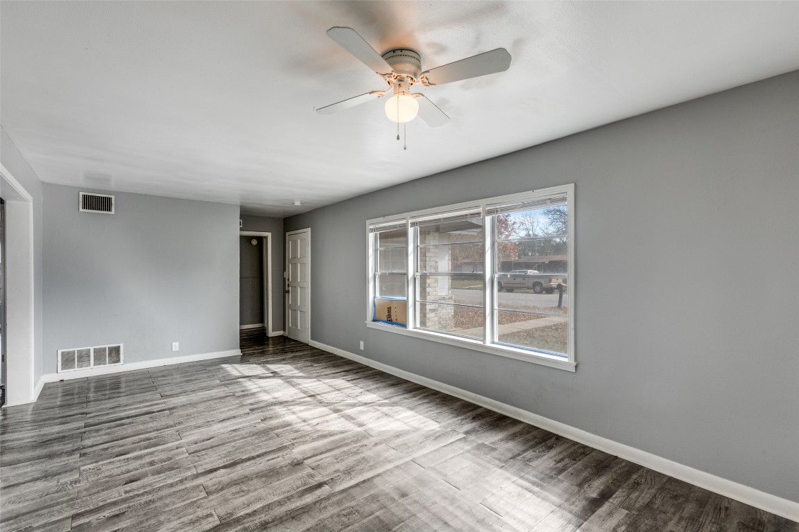 705 Campbell Street Lockhart, TX 78644 - Photo 5 of 30 a view of an empty room with a window and wooden floor