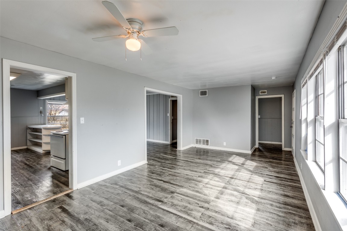 705 Campbell Street Lockhart, TX 78644 - Photo 8 of 30 wooden floor in an empty room with a window