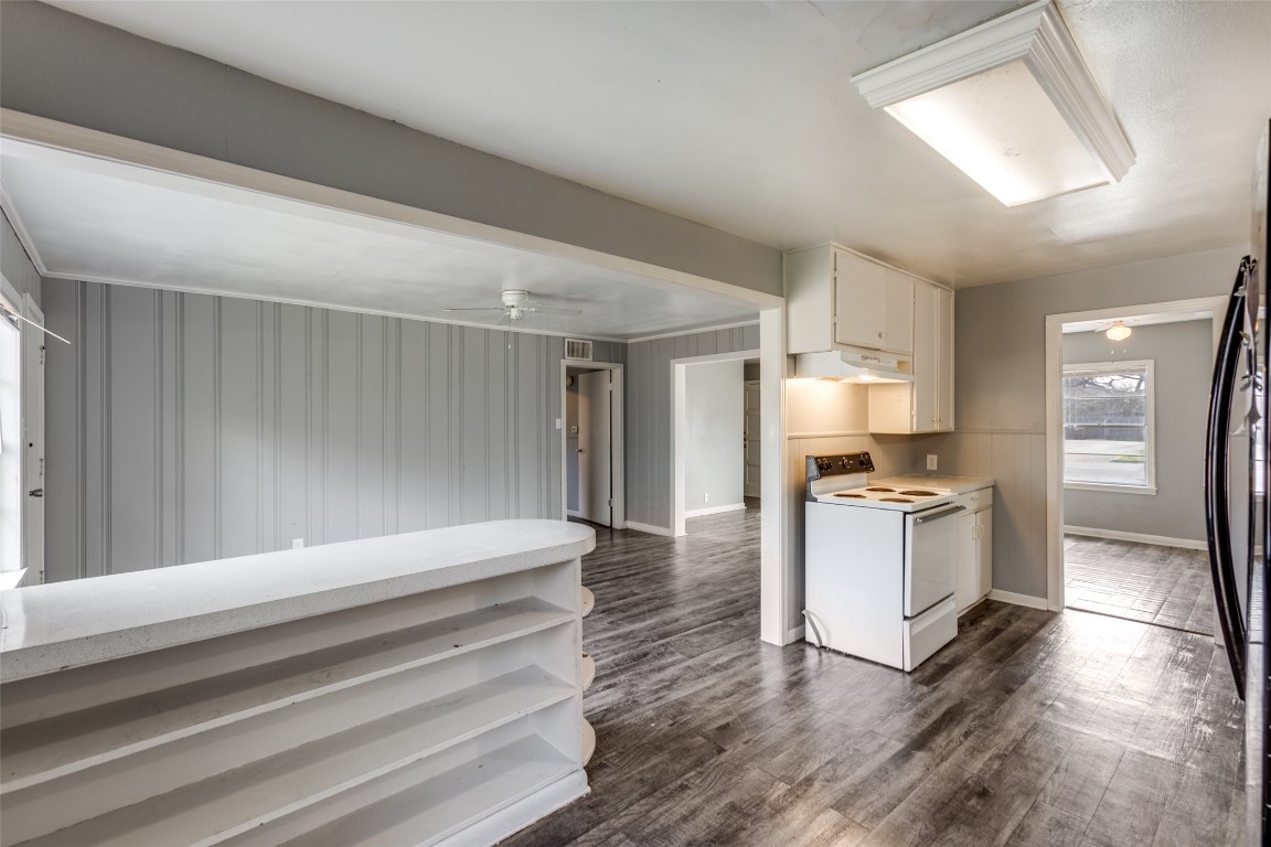 705 Campbell Street Lockhart, TX 78644 - Photo 9 of 30 a kitchen with granite countertop a refrigerator and a stove top oven