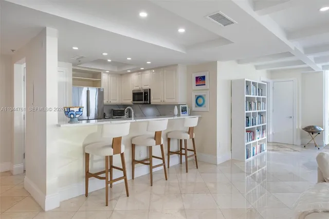 a kitchen with kitchen island cabinets and chairs in it