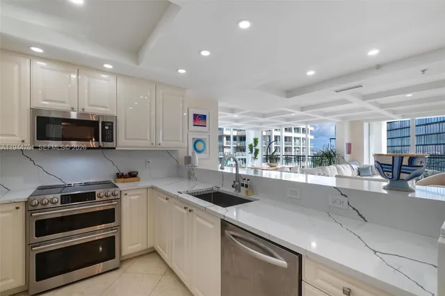 a kitchen with stainless steel appliances and white cabinets